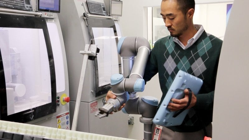 Cobot and man at Glidewell lab